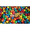 young happy boy having fun while playing and hiding in pool with colorful balls at childrens playroom