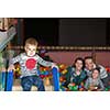 happy family enjoying free time young parents and kids playing in the pool with colorful balls at childrens playroom