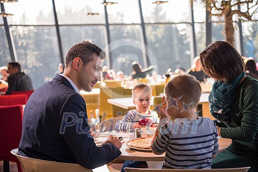 happy family enjoying lunch time together young parents with kids enjoying delicious meal at luxury restaurant happy family enjoying lunch time together young parents with kids enjoying delicious meal at luxury restaurant