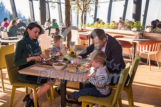 happy family enjoying lunch time together young parents with kids enjoying delicious meal at luxury restaurant happy family enjoying lunch time together young parents with kids enjoying delicious meal at luxury restaurant