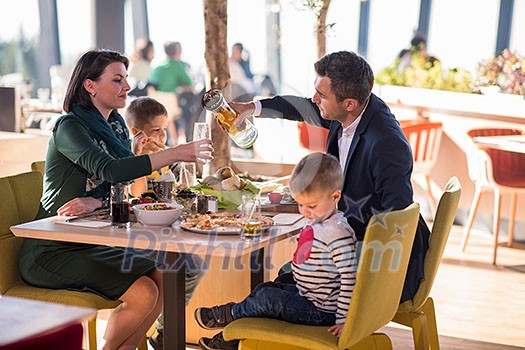 happy family enjoying lunch time together young parents with kids enjoying delicious meal at luxury restaurant happy family enjoying lunch time together young parents with kids enjoying delicious meal at luxury restaurant