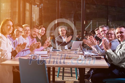 Group of a young business people brainstorming and discussing business plan on meeting at sunny bright office interior Group of a young business people brainstorming and discussing business plan on meeting at sunny bright office interior