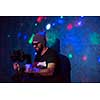 young videographer with gimball video slr working in kids neon disco party