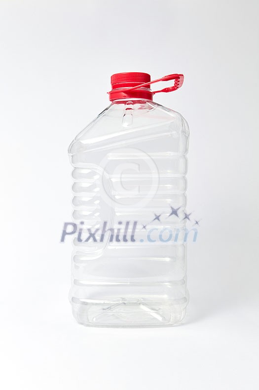Big plastic transparent empty container for water and different liquid on a light gray background, mockup. Place for text. Big plastic transparent empty container for water and different liquid on a light gray background, mockup. Place for text.