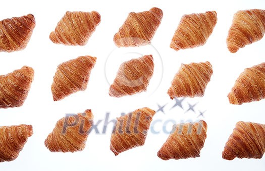 Freshly baked homemade delicious croissants pattern on a white background. Continental breakfast concept. Freshly baked homemade delicious croissants pattern on a white background. Continental breakfast concept.