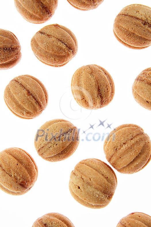 Bakery pattern from homemade fresh cookies in a shape of nuts on a white background. Bakery pattern from homemade fresh cookies in a shape of nuts on a white background.