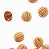 Food pattern with freshly baked homemade cakes in a shape of walnuts filled a condensed milk cream on a white background, copy space.