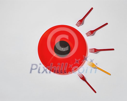 Creative composition with red vinyl record and plastic colored forks on a gray background. Concept of fertilized egg by sperms. Creative composition with red vinyl record and plastic colored forks on a gray background. Concept of fertilized egg by sperms.