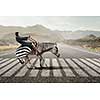 Young pretty fearless woman riding zebra animal