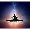 Silhouette of woman meditating in yoga position on the top. Mixed media