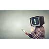 Man with TV monitor instead of head using tablet pc. Mixed media