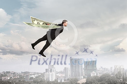 Businessman with dollar banknotes as wings flying in sky. Mixed media Businessman with dollar banknotes as wings flying in sky. Mixed media