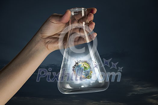 Hand holding glass tube with Earth planet inside. Elements of this image are furnished by NASA Hand holding glass tube with Earth planet inside. Elements of this image are furnished by NASA