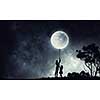 Young happy family of mother and daughter catching moon with rope