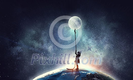 Image of little cute girl with moon on rope. Elements of this image are furnished by NASA Image of little cute girl with moon on rope. Elements of this image are furnished by NASA