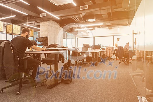 software developers working everyday job writing programming code at modern sunny bright open plan office software developers working everyday job writing programming code at modern sunny bright open plan office