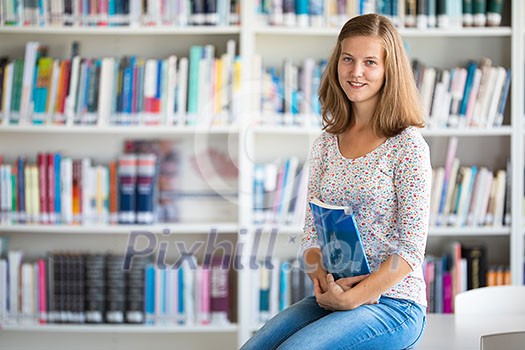 Cute female university/highschool student with books in library Cute female university/highschool student with books in library