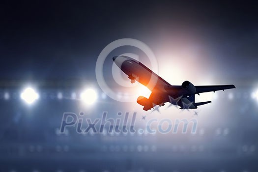 Airplane for transportation flying over airport lights Airplane for transportation flying over airport lights