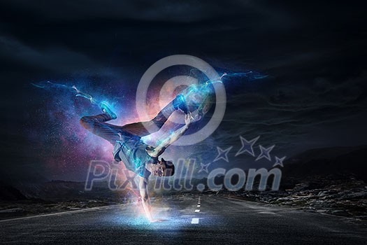 Breakdancer in jump against night sky background. Mixed media Breakdancer in jump against night sky background. Mixed media