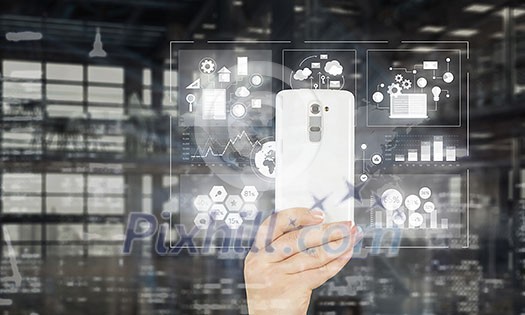 Hand holding smartphone with media application icons Hand holding smartphone with media application icons