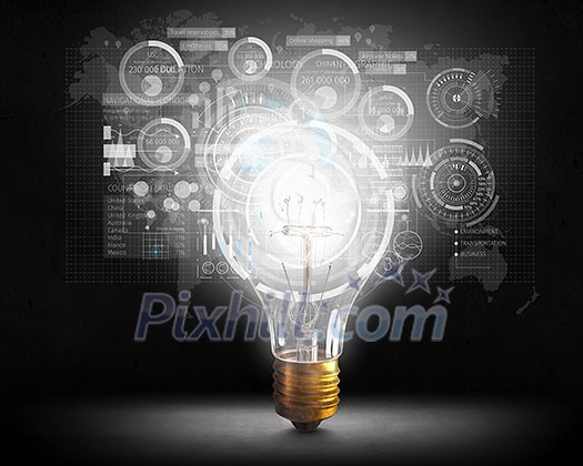 Glowing light bulb on dark background and technology concept . Mixed media Glowing light bulb on dark background and technology concept . Mixed media