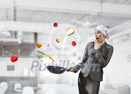 Young elegant businesswoman in suit and cook hat with pan in hands. Mixed media Young elegant businesswoman in suit and cook hat with pan in hands. Mixed media