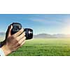 Close of professional photographer holding photo camera