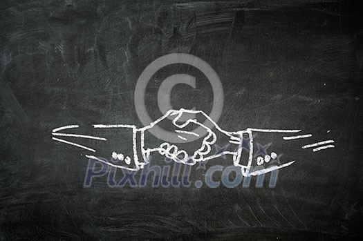 Handshaking sign drawn in chalk on blackboard. Mixed media Handshaking sign drawn in chalk on blackboard. Mixed media