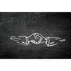 Handshaking sign drawn in chalk on blackboard. Mixed media
