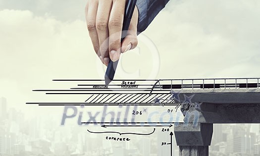 Hand of designer drawing bridge with stylus. Mixed media Hand of designer drawing bridge with stylus. Mixed media