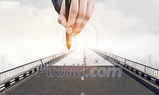 Hand of designer drawing bridge with stylus. Mixed media Hand of designer drawing bridge with stylus. Mixed media