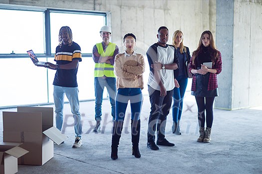 young multiethnic team of business people in group, architect and engineer on construction site checking documents and business workflow using laptop and tablet computer in new startup office young multiethnic team of business people in group, architect and engineer on construction site checking documents and business workflow using laptop and tablet computer in new startup office