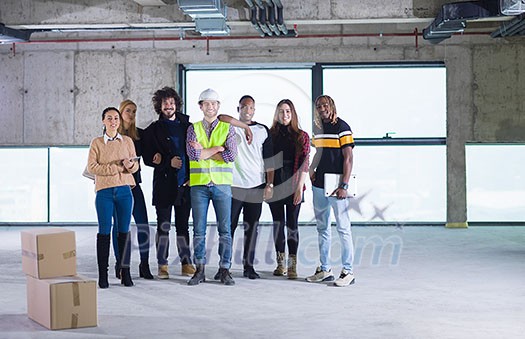 young multiethnic team of business people in group, architect and engineer on construction site checking documents and business workflow using laptop and tablet computer in new startup office young multiethnic team of business people in group, architect and engineer on construction site checking documents and business workflow using laptop and tablet computer in new startup office