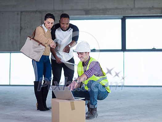 young multiethnic team of business people in group, architect and engineer on construction site checking documents and business workflow using laptop and tablet computer in new startup office young multiethnic team of business people in group, architect and engineer on construction site checking documents and business workflow using laptop and tablet computer in new startup office