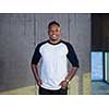 portrait of young african american male architect on construction site while checking documents and business workflow in new startup office