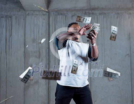 business, people and finances concept Happy young african american businessman throwing US dollar banknotes and enjoying while making the rain of money in new startup office business, people and finances concept Happy young african american businessman throwing US dollar banknotes and enjoying while making the rain of money in new startup office