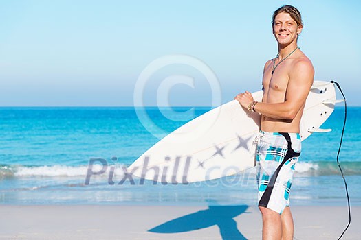 A young surfer with his board on the beach A young surfer with his board on the beach