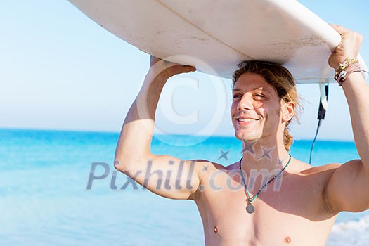 A young surfer with his board on the beach A young surfer with his board on the beach