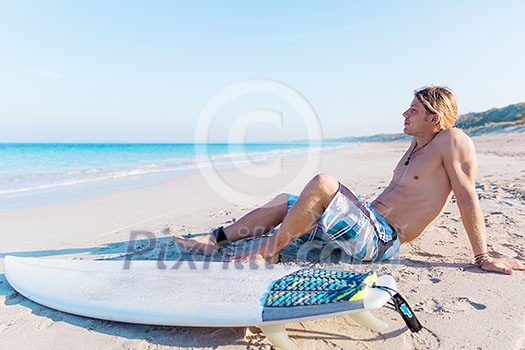 A young surfer with his board on the beach A young surfer with his board on the beach