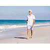 Man in white clothes on the beach on sunny day