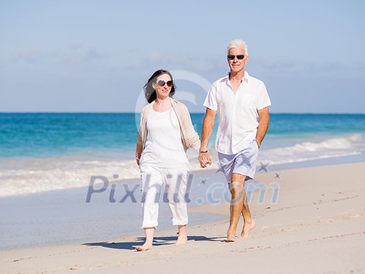 Couple walking on the beach Couple walking on the beach