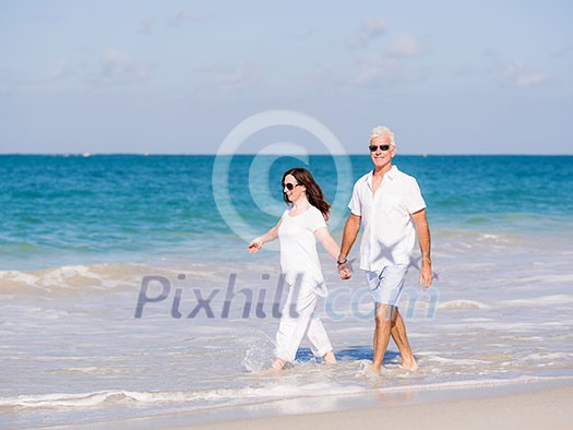 Couple walking on the beach Couple walking on the beach