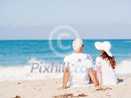 Couple sitting on the beach Couple sitting on the beach