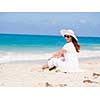 Woman in white clothes on the beach on sunny day