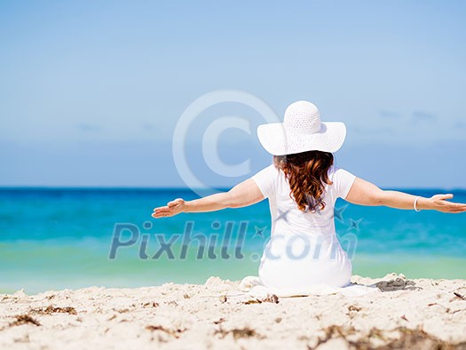 Woman in white clothes on the beach on sunny day Woman in white clothes on the beach on sunny day