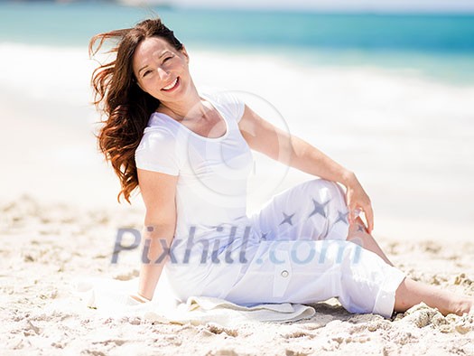 Woman in white clothes on the beach on sunny day Woman in white clothes on the beach on sunny day
