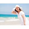 Woman in white clothes on the beach on sunny day