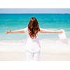 Woman in white clothes on the beach on sunny day