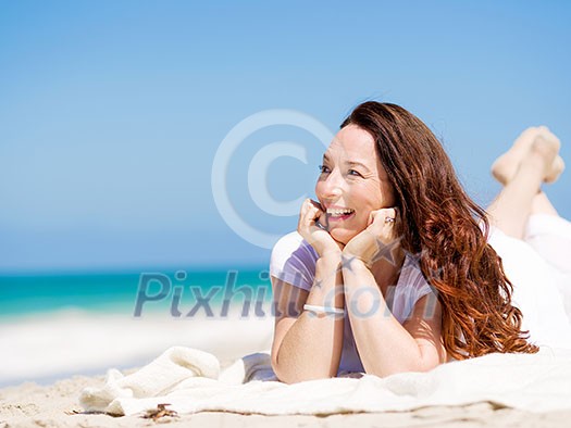 Woman in white clothes on the beach on sunny day