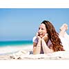 Woman in white clothes on the beach on sunny day